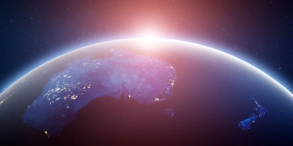 Australia, New Zealand world view with the sun appearing over the curve of the Earth