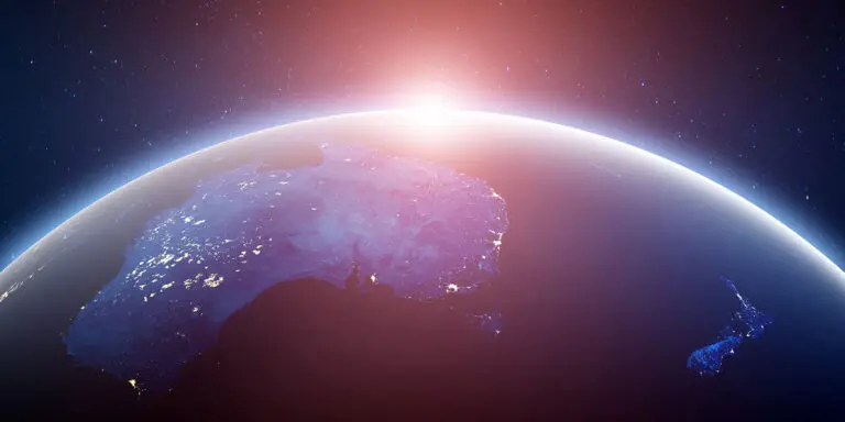 Australia, New Zealand world view with the sun appearing over the curve of the Earth